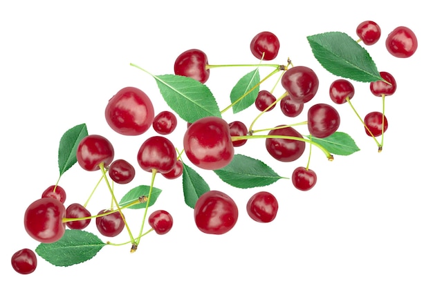 Flying ripe cherries with green foliage isolated on white background