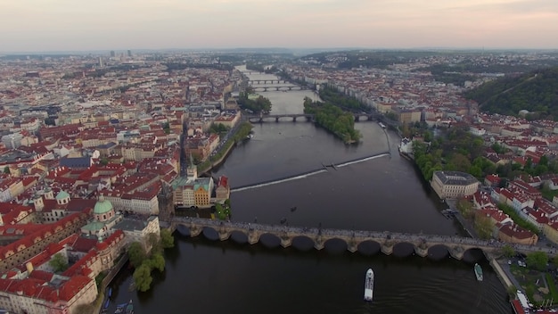 Flying over vltava river with charles bridge in prague