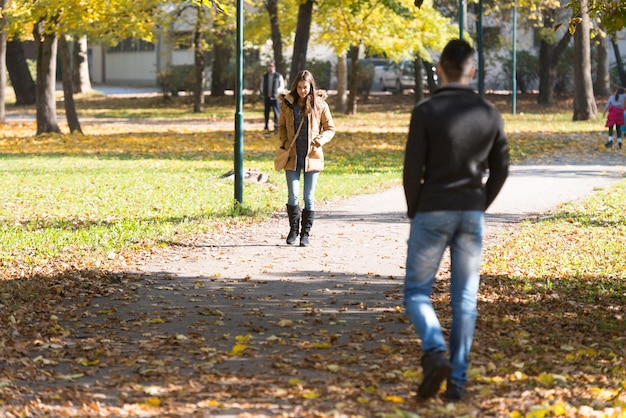 Flyrting Walking Next to Each Other in Park