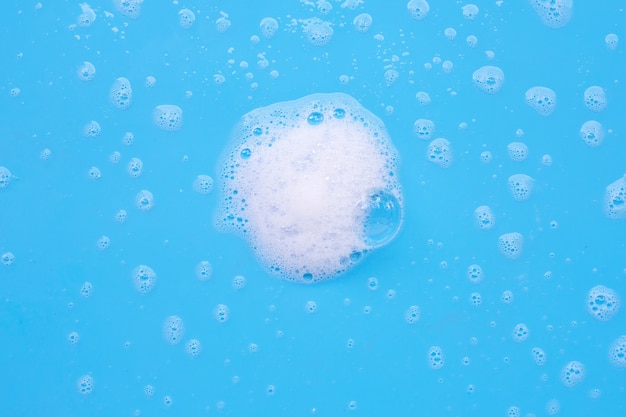 Foam on blue background. Top view