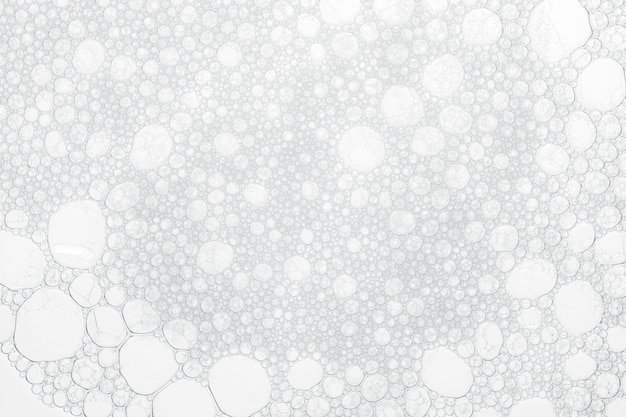 Photo foam bubbles from soap or shampoo washing on white background.