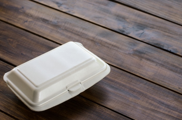 Foam food boxes are placed on wooden boards.