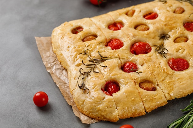 Focaccia bread with garlic cherry tomatoes rosemary and olive oil Baked flat garlic bread  top view