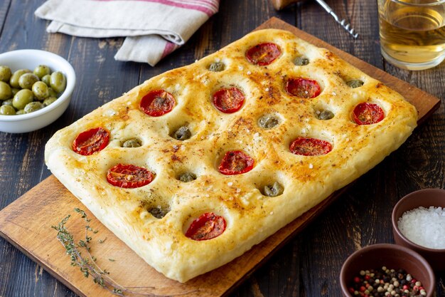 Focaccia with tomatoes and olives. Vegetarian food. Italian food.