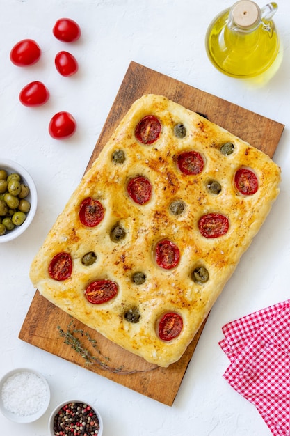 Focaccia with tomatoes and olives. Vegetarian food. Italian food.