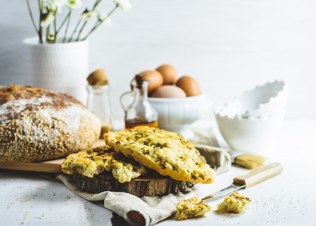 Foccacia, flatbread, some eggs, oil, sesame.