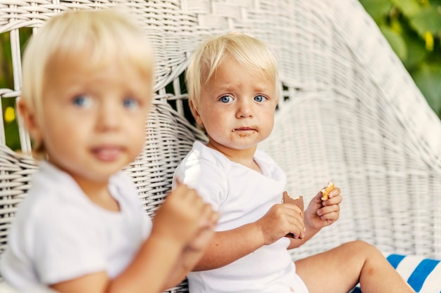 Focus on the face of a twin toddler boy with pure sky blue eyes