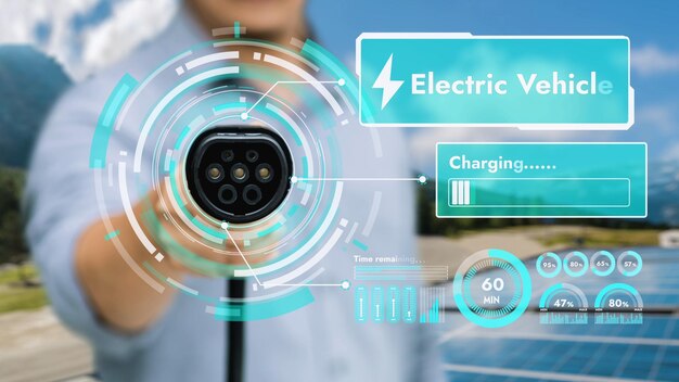 Focus hand pointing EV charger in front of camera display smart battery status hologram in blur green electricity generator Electric car charger using clean energy reducing CO2 emissionPeruse