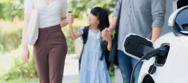 Focus home charging station for EV car blur progressive family in background