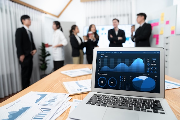 Focus laptop display BI with blurred background of office worker in harmony