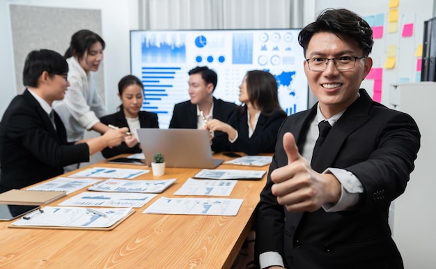 Focus portrait male manager in harmony office with businesspeople in background