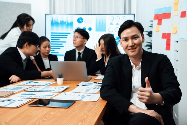 Focus portrait male manager in harmony office with businesspeople in background