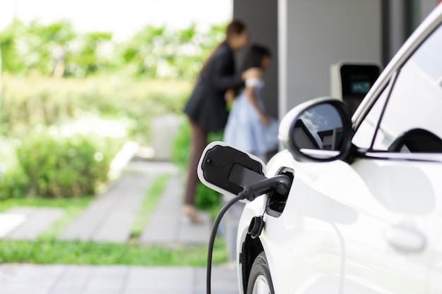 Focus progressive EV car at home with blur woman in background