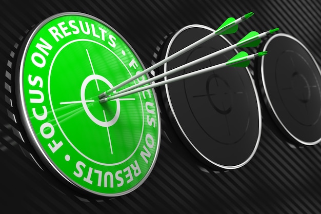 Photo focus on results slogan. three arrows hitting the center of green target on black background.