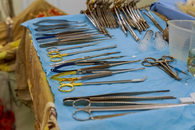 Focus at the scaples,the tools including scalpels, forceps and tweezers arranged on a table for a surgery