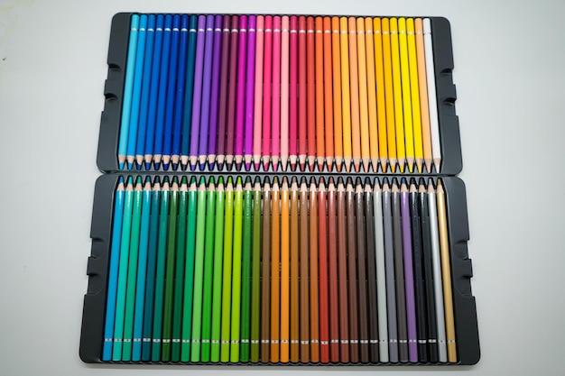 Focus sets of color pencils in pencil case on a white background