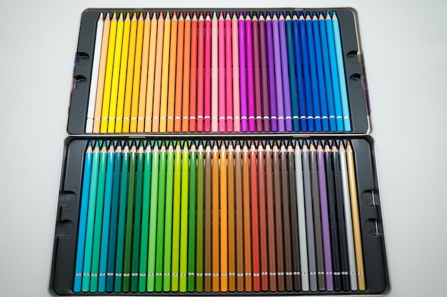 Focus sets of color pencils in pencil case on a white background