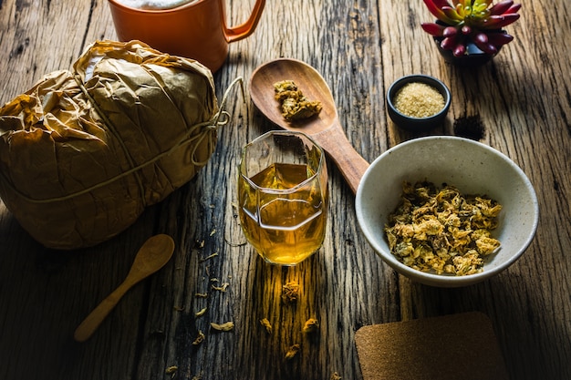 Focus Spot Chrysanthemum Tea and dried chrysanthemum on an old wooden table.