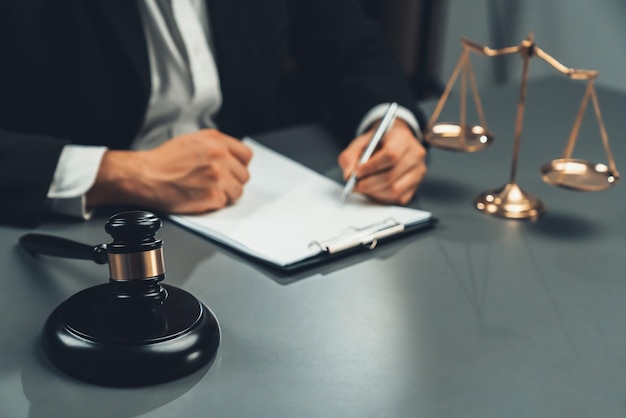 Focus symbols of justice on blurred background of lawyer signing equility