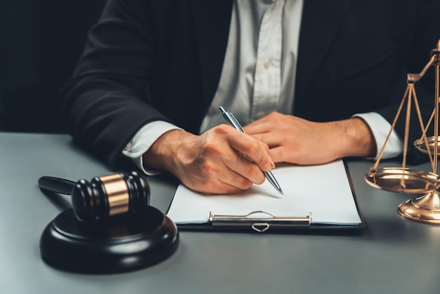 Focus symbols of justice on blurred background of lawyer signing equility