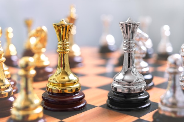 Focus on two Queens next to each other among other chess pieces The concept of confrontation the struggle of leaders the strategy of winning in a chess game