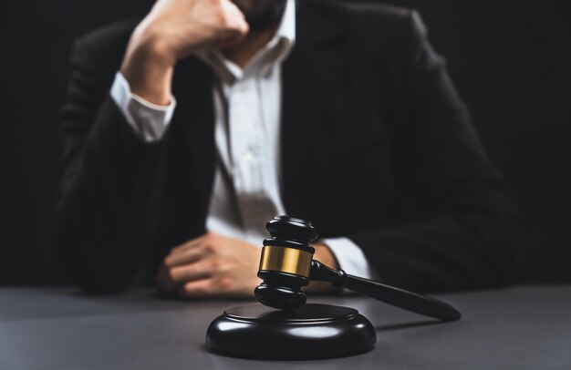 Focus wooden gavel with burred background of lawyer equility