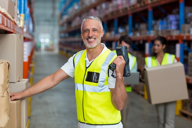 Focus of worker is smiling and posing during work