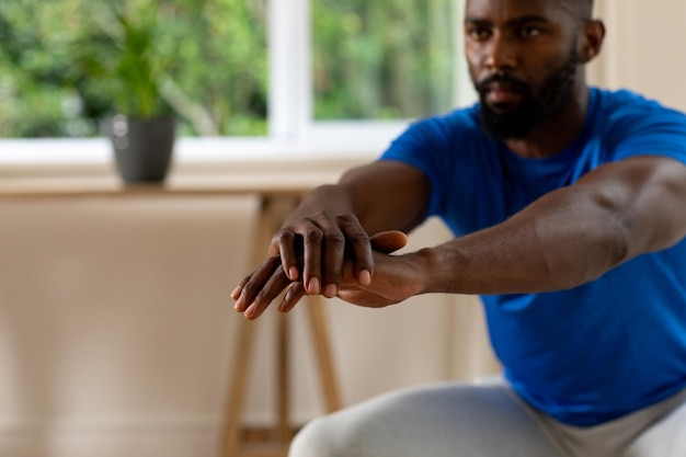 Photo focused african american man exercising at home