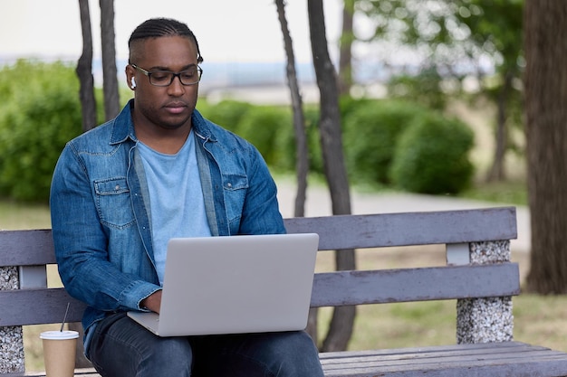 Сосредоточенный африканец нервно ждет важного электронного письма от делового партнера
