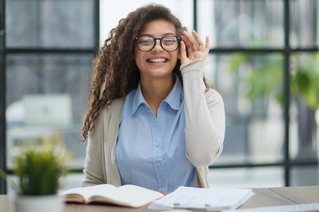 Focused agent girl lawyer manager sitting at workplace