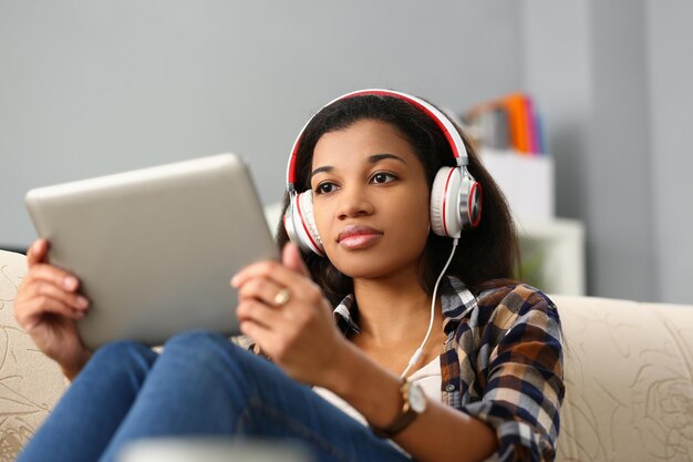 Focused black woman studying foreign language online