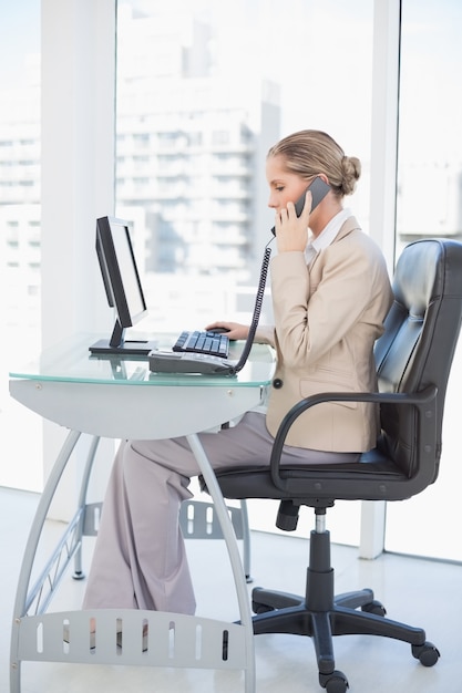 Focused blonde businesswoman on the phone