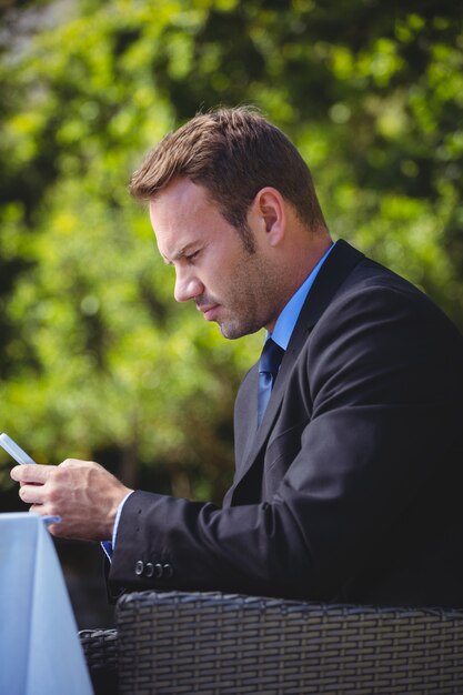 Focused businessman looking at his smartphone