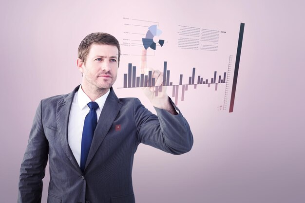 Focused businessman pointing with finger against grey vignette