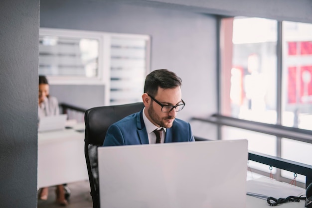 A focused businessman working on computer at office