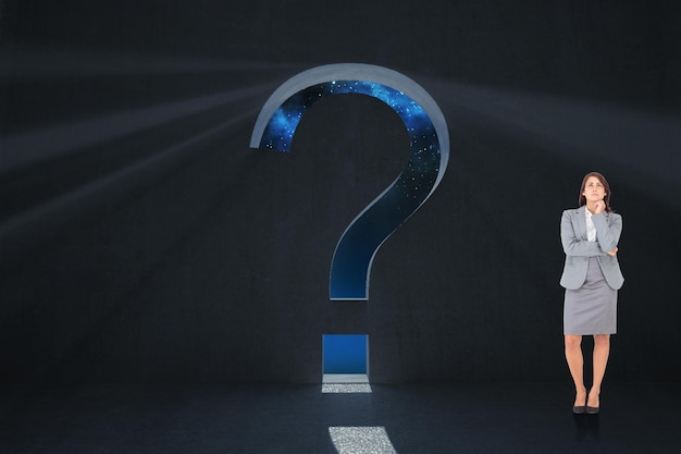 focused businesswoman against question mark door in dark room