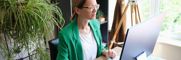 Focused businesswoman works at computer in office