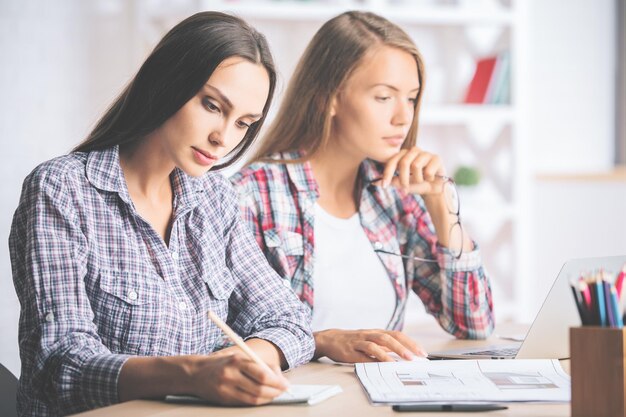 Focused businesswomen working on project