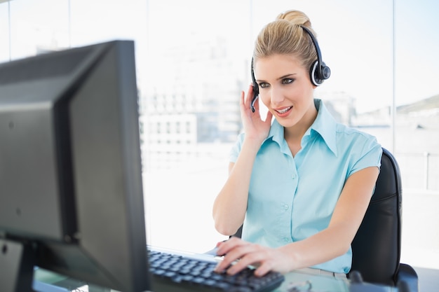 Photo focused call centre agent working on computer