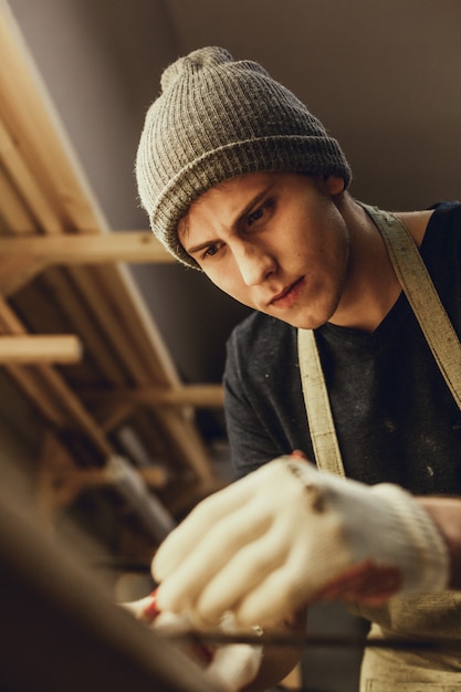 Focused carpenter making marks on plank