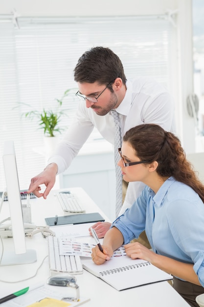 Focused colleagues using computer together 