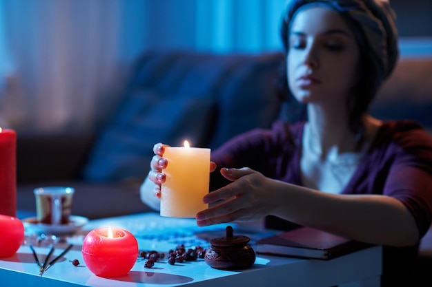 Focused female fortune-teller cleansing her divination table