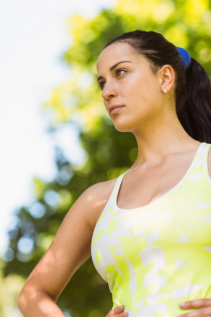 Focused fit brunette in the park on a sunny day