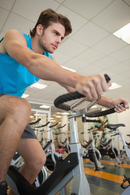focused fit man on the spin bike