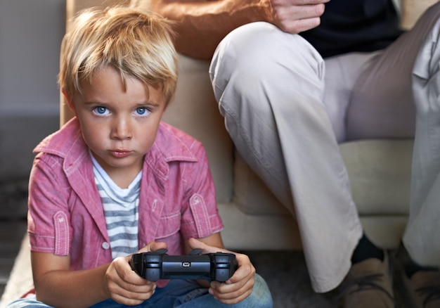 Focused on the game A young boy playing video games at home