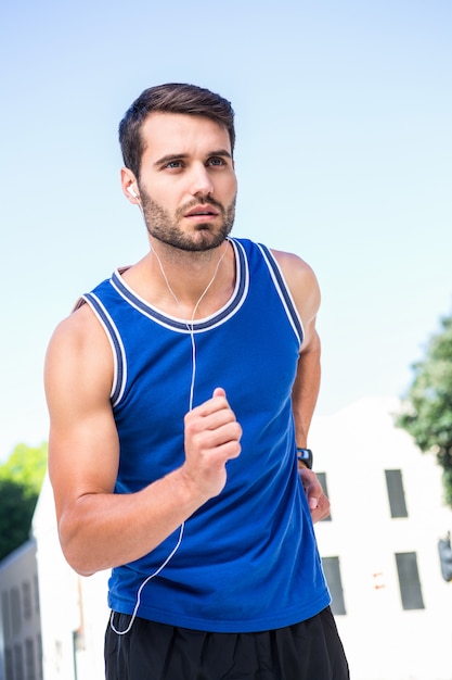 Photo focused handsome athlete jogging