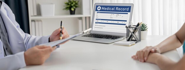 Photo focused laptop display medical report or diagnostic result of patient health on blurred background of doctor's appointment in hospital medical consultation and healthcare treatment panorama rigid