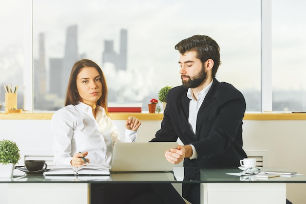 Focused male and female working together