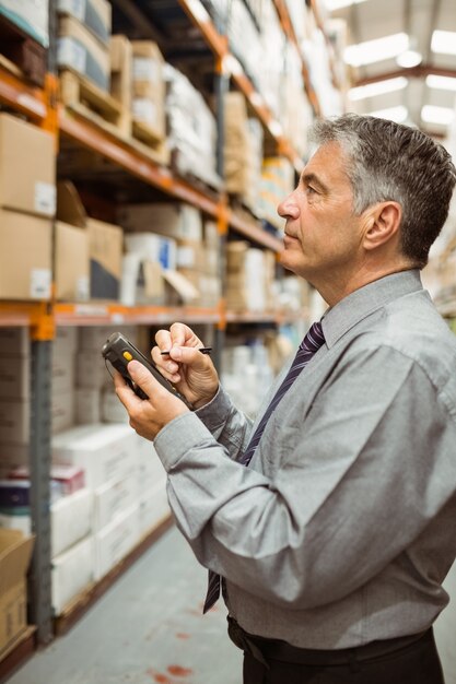 Focused male manager using handheld