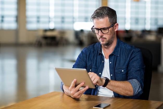 Focused man using digital tablet